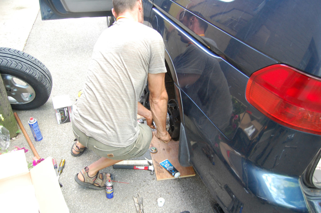 Tightening the big 36MM spindle nut with a socket wrench. It called for 180 ft-lbs of torque, but we had no torque wrench. So I just applied almost all my weight to the 1-foot wrench, which should be very close.