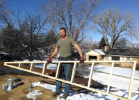 Mr. Money Mustache carries the first wall of the new roof structure into place. A great start to 2014.