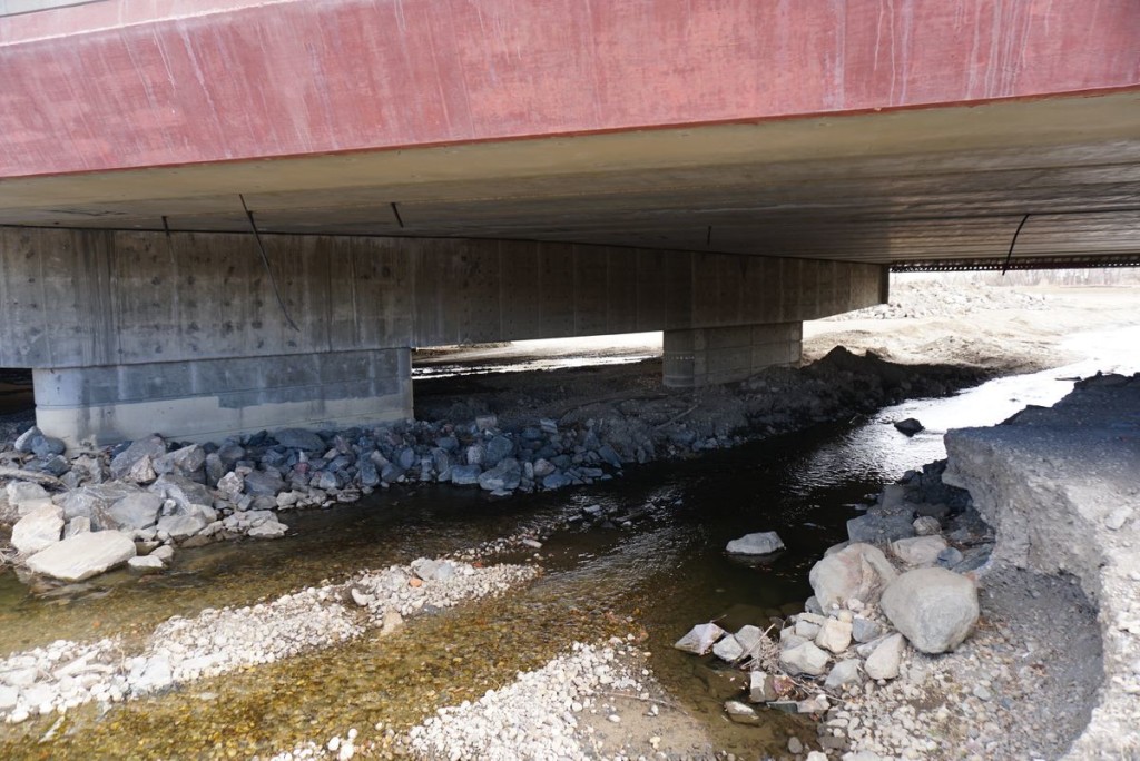 Here's a peek under the bridge. Although you rarely look at this stuff, you definitely pay for it. Just post and beam like this consumes between 500,000 and 1 million pounds of concrete.